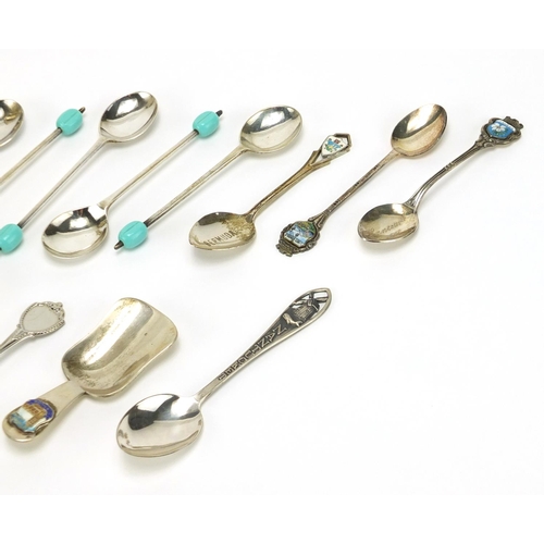 2364 - Silver and white metal cutlery including a pair of sterling casters, a sterling caddy spoon and souv... 