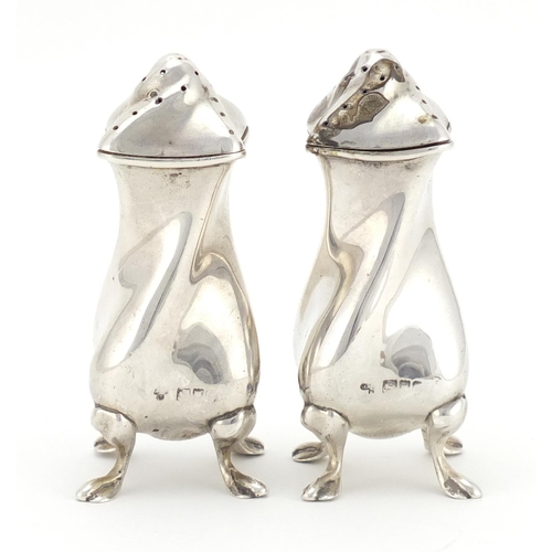 2348 - Pair of silver four footed casters, indistinct hallmarks, each 9cm high, approximate weight 121.0g