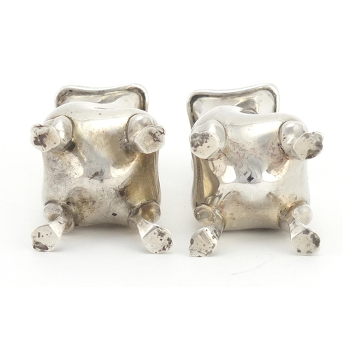 2348 - Pair of silver four footed casters, indistinct hallmarks, each 9cm high, approximate weight 121.0g