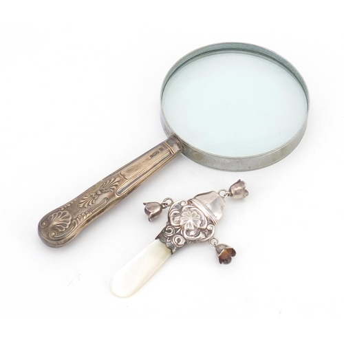 2351 - Silver and mother of pearl babies rattle and a silver handled magnifying glass, the largest 19cm in ... 
