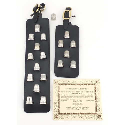 2363 - Nineteen silver thimbles by Swann, mounted on black leather straps