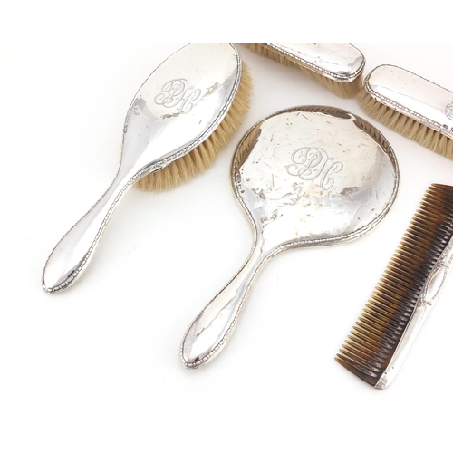 2371 - Silver five piece dressing table set including hand mirror and brushes, various Chester hallmarks, t... 