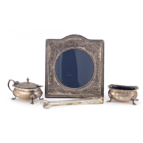 2362 - Silver items comprising easel photo frame embossed with swags, a mustard and open salt by Goldsmith ... 