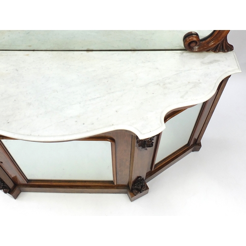 2001 - Victorian walnut serpentine fronted credenza, with mirrored back and marble top above three glazed d... 