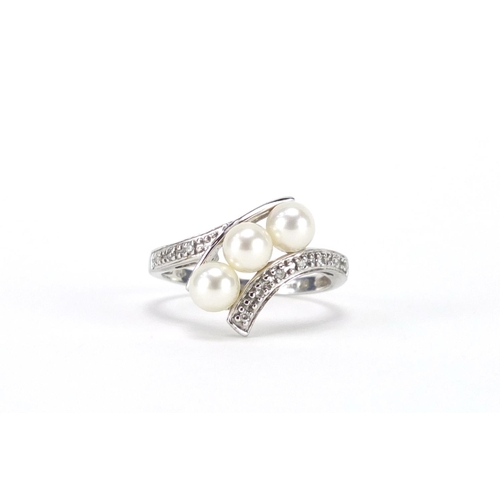 2451 - 9ct white gold pearl and diamond crossover ring, size N, approximate weight 2.7g