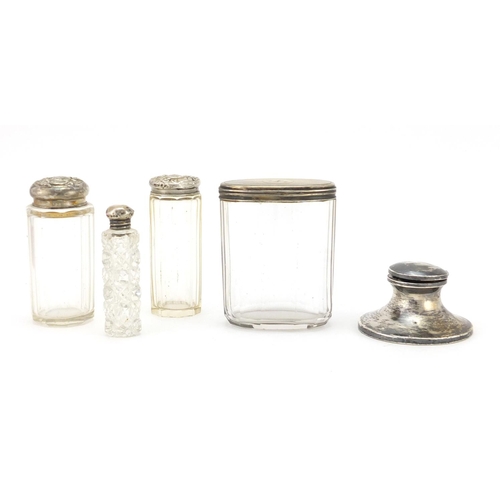 2379 - Four cut glass jars and bottles with silver lids and a silver inkwell, various hallmarks, the larges... 