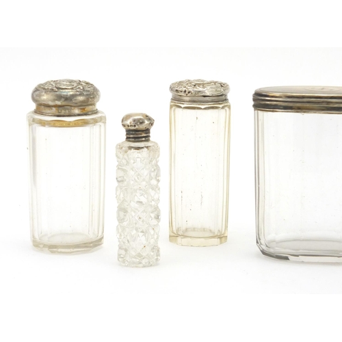 2379 - Four cut glass jars and bottles with silver lids and a silver inkwell, various hallmarks, the larges... 