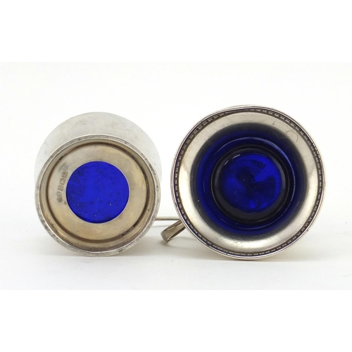 2381 - Silver mustard with hinged lid and open salt, both with blue glass liners, Birmingham hallmarks, the... 
