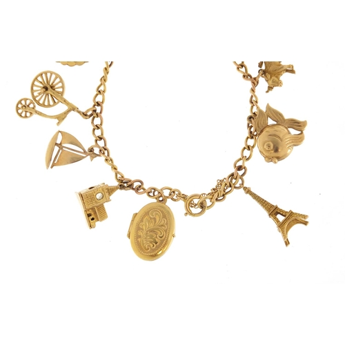 2384 - 9ct gold charm bracelet with a selection of mostly 9cct gold charms including cathedral, lantern, Ei... 