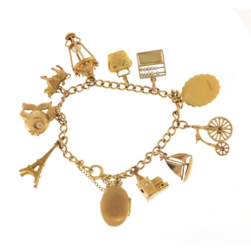 2384 - 9ct gold charm bracelet with a selection of mostly 9cct gold charms including cathedral, lantern, Ei... 