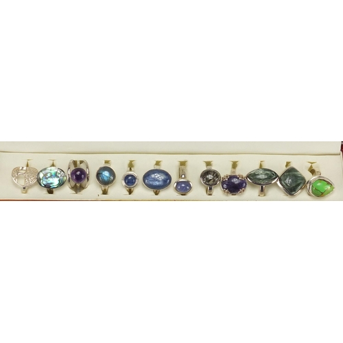 2475 - Twelve silver semi precious stone rings, housed in a display box, various sizes, approximate weight ... 