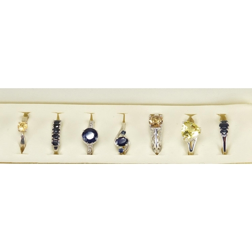2478 - Twelve silver semi precious stone rings,  housed in a display box, various sizes, approximate weight... 