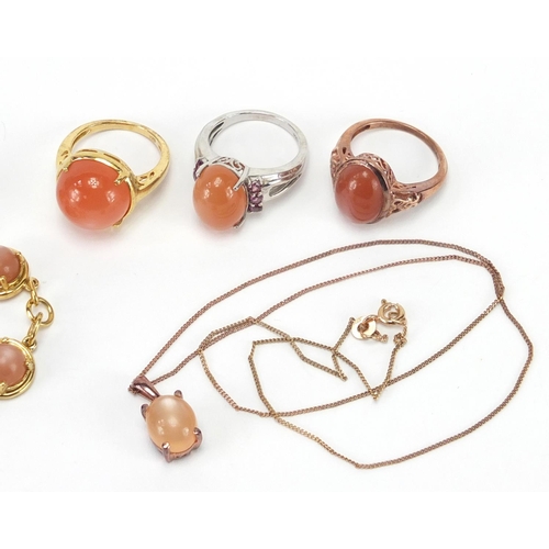 2454 - Silver gilt and cabochon pink stone jewellery comprising three rings, bracelet, two pairs of earring... 