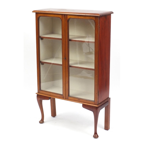 142 - Mahogany bookcase with glazed doors enclosing two shelves on cabriole feet, 107cm H x 66cm W x 25cm ... 