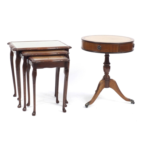 184 - Reproduction circular mahogany drum table with leather top and nest of three mahogany tables, the dr... 