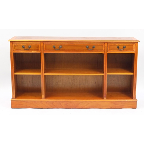 120 - Inlaid yew bookcase with three drawers above open shelves, 84cm H x 152cm W x 31cm D