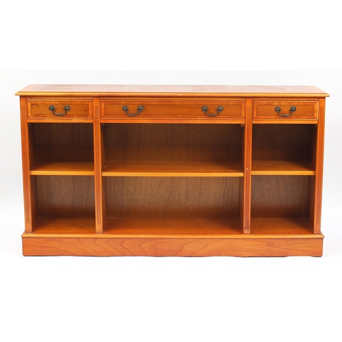 120 - Inlaid yew bookcase with three drawers above open shelves, 84cm H x 152cm W x 31cm D