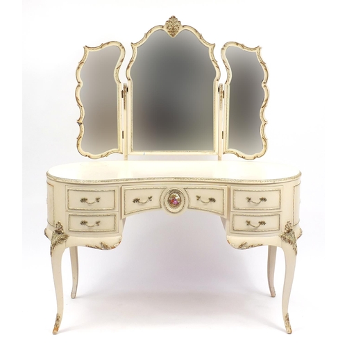 82 - French style cream and gilt kidney shape dressing table with triple mirror and five drawers, the cen... 