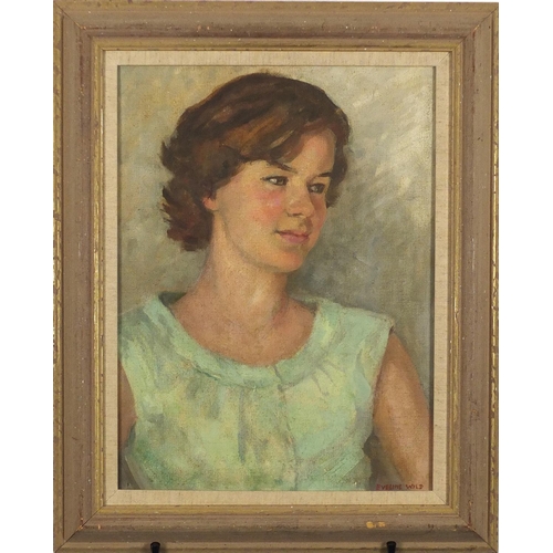 910 - Winifred Eveline Wild - Portrait of a girl in a green dress, signed oil on canvas board, mounted and... 