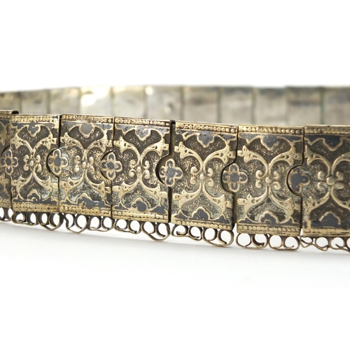 371 - Indian 700 grade silver wedding belt, decorated with a repeat flower head design, each link impresse... 
