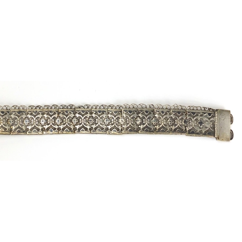 371 - Indian 700 grade silver wedding belt, decorated with a repeat flower head design, each link impresse... 
