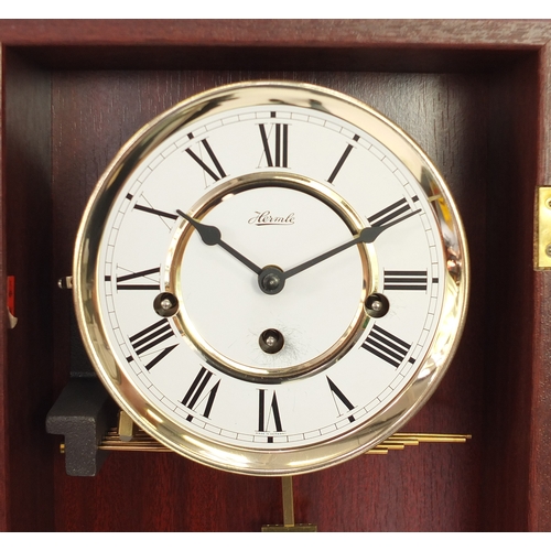 285 - Mahogany cased Hermle Westminster chiming wall hanging clock, 66cm in length