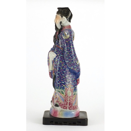 201 - Chinese porcelain emperor hand painted in the famille rose palette raised on a carved hardwood stand... 