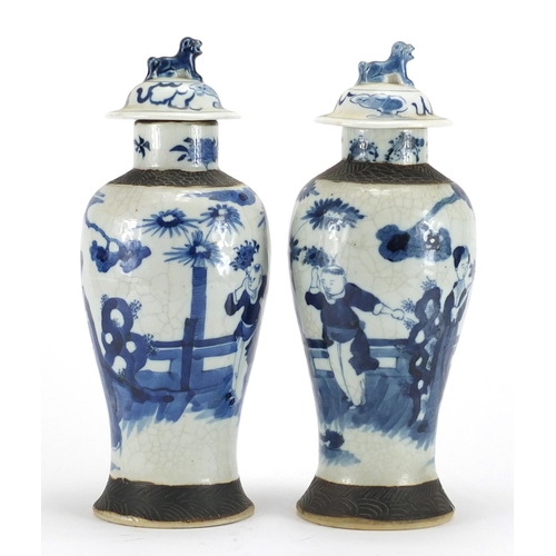 242 - Pair of Chinese blue and white crackle glazed baluster vases and covers, hand painted with figures, ... 