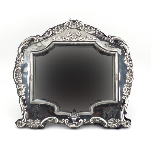 514 - Large silver easel mirror with bevelled glass and embossed with shells and swags, indistinct makers ... 