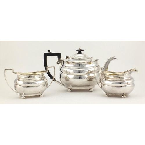 525 - Silver three piece tea set, by Josiah Williams & Co London 1928 and 1931, the teapot 15.5cm high, ap... 