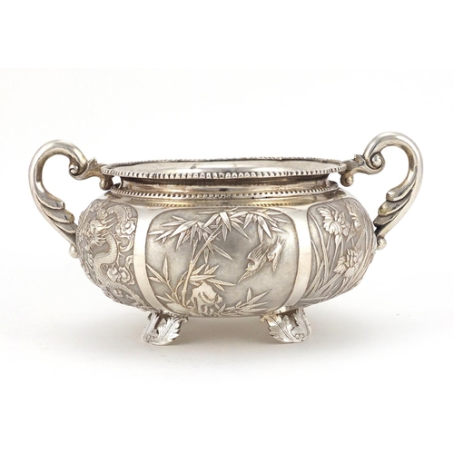 515 - Chinese silver twin handled bowl embossed with dragons, birds, insects and flowers, impressed W A to... 