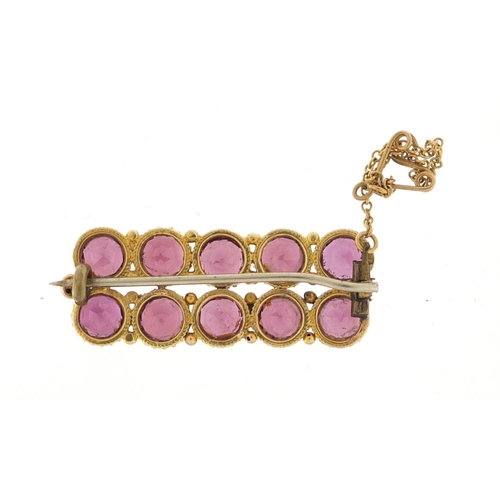 606 - Unmarked gold amethyst bar brooch, 3.6cm in length, approximate weight 8.1g