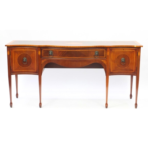 2071 - Inlaid mahogany serpentine front sideboard with brass lion mask handles, raised on tapering legs, 90... 