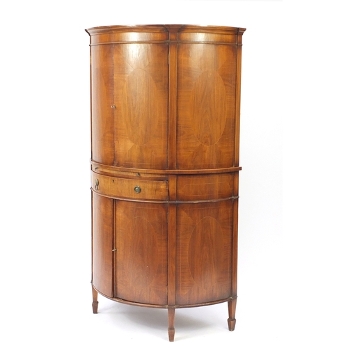 2113 - Inlaid walnut bow fronted cocktail cabinet, fitted with a pair of doors above a mixing shelf with dr... 