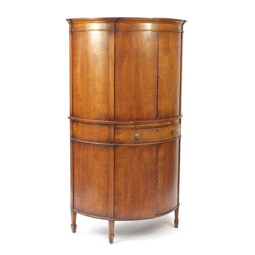 2113 - Inlaid walnut bow fronted cocktail cabinet, fitted with a pair of doors above a mixing shelf with dr... 