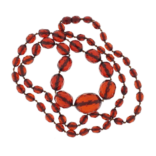 663 - Amber coloured faceted bead necklace with earrings, the necklace 84cm in length, approximate weight ... 