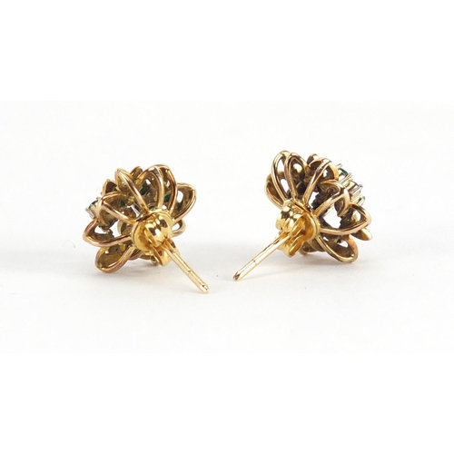610 - *Description amended 10-07-19* Pair of unmarked gold emerald and diamond flower head earrings, the b... 