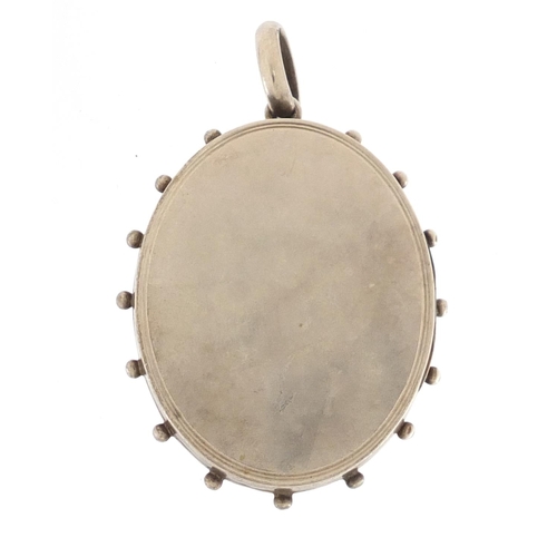 658 - Victorian aesthetic unmarked silver locket, 5.8cm in length, approximate weight 23.2g