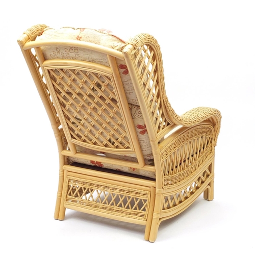 117 - Wicker and cane conservatory chair with floral upholstered cushions, 100cm high