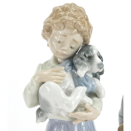 2215 - Two Lladro figures including Winter both with boxes, numbered 5220 and 7609, the largest 21cm high