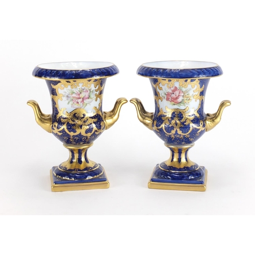 315 - Pair of Limoges porcelain twin handled vases with hand gilded decoration, 18cm high