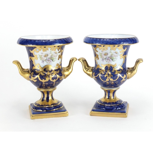 315 - Pair of Limoges porcelain twin handled vases with hand gilded decoration, 18cm high