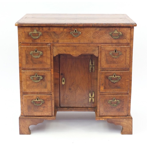 2019 - Antique walnut kneehole desk with quarter veneered top, cross banded and feather banded drawers abov... 