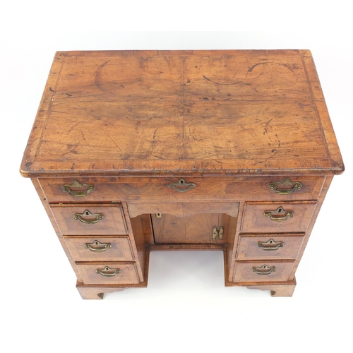 2019 - Antique walnut kneehole desk with quarter veneered top, cross banded and feather banded drawers abov... 