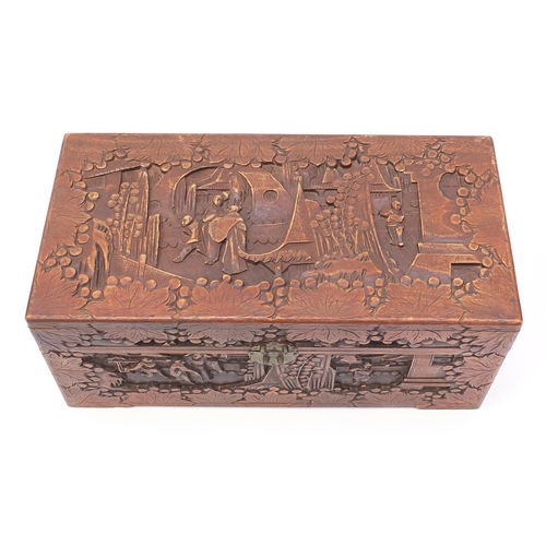 28 - Camphorwood chest carved with figures and buildings, 35cm H x 73cm W x 36cm D