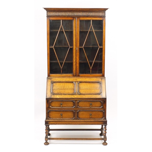 2067 - Edwardian Oak bureau bookcase with pair of glazed doors enclosing three shelves above a fall, with f... 