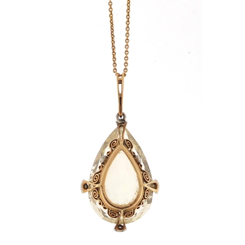 584 - Unmarked gold citrine and diamond tear drop pendant on an unmarked gold necklace, the pendant 4.2cm ... 