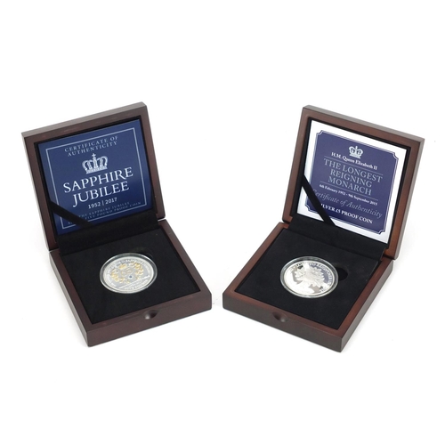 2581 - Two commemorative silver proof five pound coins, with fitted boxes comprising The Longest Reigning M... 