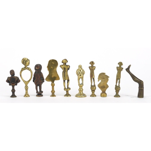 63 - Ten antique pipe tampers including Napoleon, bust of a female and leg design examples, the largest 7... 