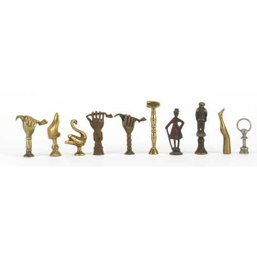 64 - Ten antique pipe tampers including swan, figural, boot and hand design examples, the largest 6.5cm h... 